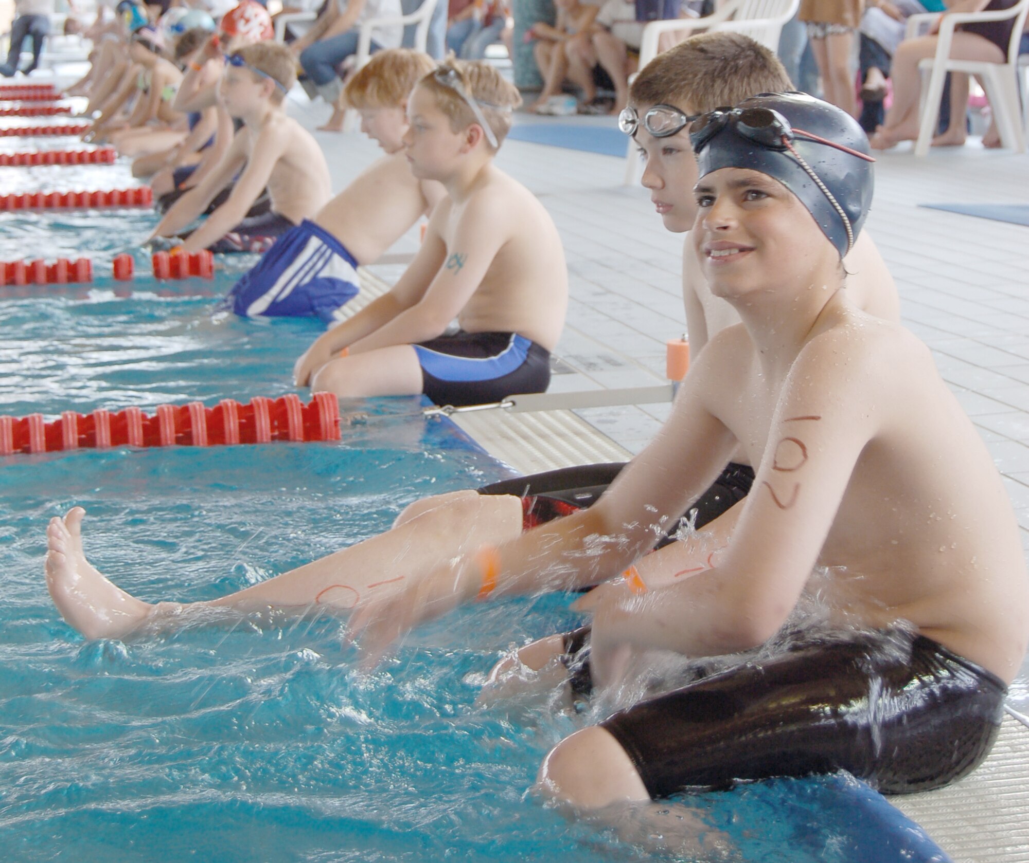 Children wait to participate in the first heat of the swimming portion at the second annual FitFactor Triathlon May 2, 2010, at Ramstein Air Base, Germany. Participants swam either 200 or 500 meters, depending on their age category. (U.S. Air Force photo/Senior Airman Amanda Dick)