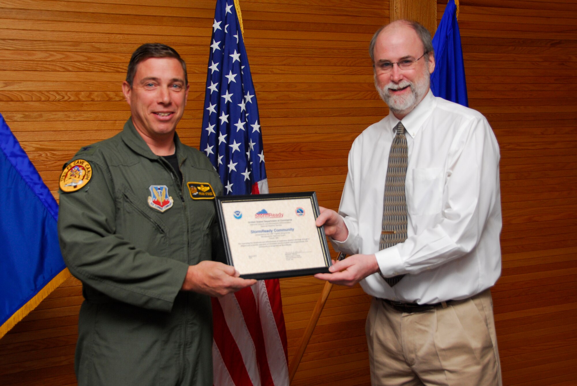 Mr. Michael R. Stewart, meteorologist in charge of the Duluth, Minn., National Weather Service presents U.S. Air Force Col. Frank Stokes, 148th Fighter Wing Commander, certification of the 148th Fighter Wing as a StormReady Community at the Duluth, Minn., ANG Base May 3, 2010.  The 148th Fighter Wing has become the first National Guard unit to be certified by the National Weather Service as a StormReady Community. (U.S. Air Force photo by Master Sgt. Jason W. Rolfe/Released)