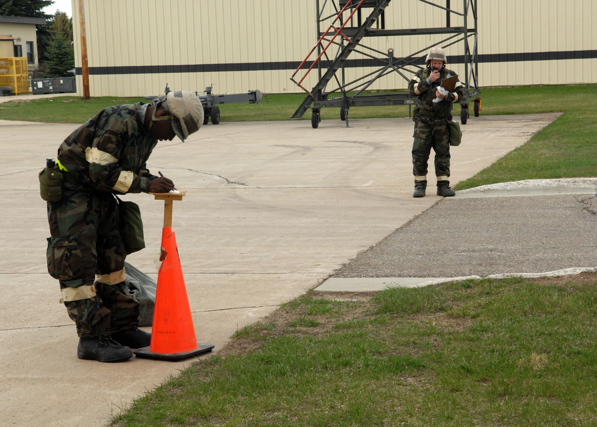 MINOT AIR FORCE BASE, N.D. -- Airman 1st Class Timothy Williams, 5th Logistics Readiness Squadron Mobility Readiness Spare Packages journeyman, checks M9 paper for contamination during an Ability To Survive and Operate, or ATSO, exercise here April 28. The focus of this exercise was to practice Ability to Survive and Operate, or ATSO skills and test the base personnel’s ability to respond to a crisis situation. (U.S. Air Force photo by Airman 1st class Aaron-Forrest Wainwright)