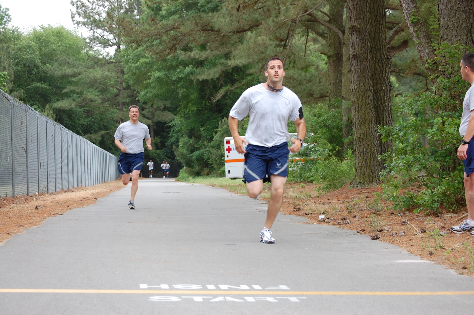 Col. Randall Ogden (left), 916th ARW commander, shows his warrior spirit as he prepares to cross the finish line during the wing's semi-annual Warrior Run held on May 2. (USAF photo by TSgt. Ian Gardner, 916 OSS)