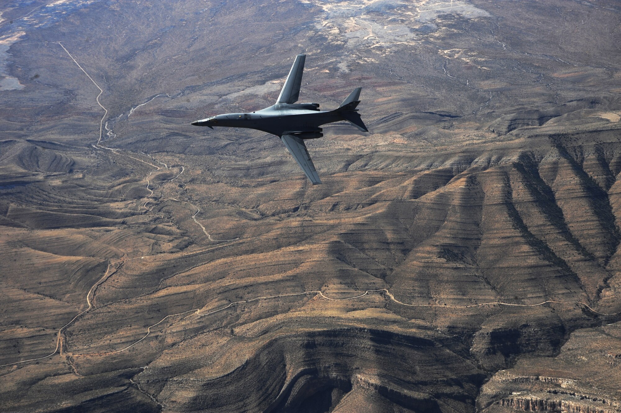 A B-1B Lancer assigned to the 28th Bomb Squadron, Dyess Air Force Base, Texas, maneuvers over New Mexico during a training mission Feb. 24, 2010.  Dyess celebrates the 25th anniversary of the first B-1B bomber arriving at the base. (U.S. Air Force photo/Master Sgt. Kevin J. Gruenwald) 
