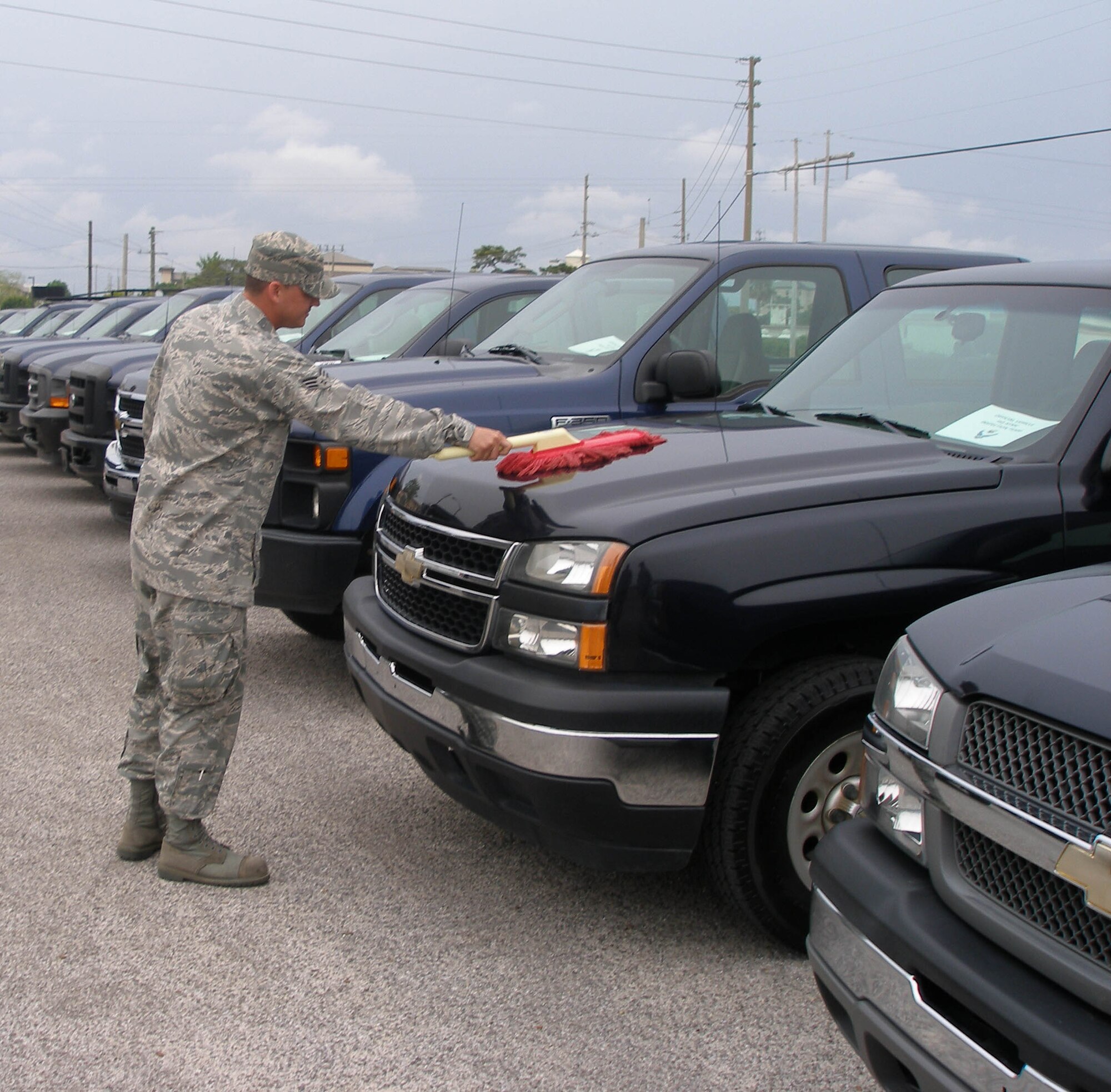 Senior Airman Kyle Young, 96th Logistics Readiness Squadron, brushes off one of the cars used by the inspectors here during the Unit Compliance Inspection.  The Air Armament Center and Air Force Research Laboratory scored high marks with inspectors the week of April 26. (courtesy photo).
