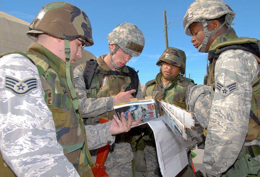 MAXWELL-GUNTER AIR FORCE BASE, Ala. – Airmen of the exercise evaluation team, “Blue Thunder,” discuss proper unexploded ordnance reporting procedures during an emergency response exercise on Maxwell-Gunter Air Force Base, Ala., in February 2009. As the host unit for Maxwell-Gunter Air Force Base, the 42nd Air Base Wing's mission is critical to national security; it provides the foundation for success for Air University, the intellectual and leadership center of the Air Force; the 908th Airlift Wing; the 754th Electronic Systems Group; and more than 30 tenant units. (U.S. Air Force photo/Jamie Pitcher)