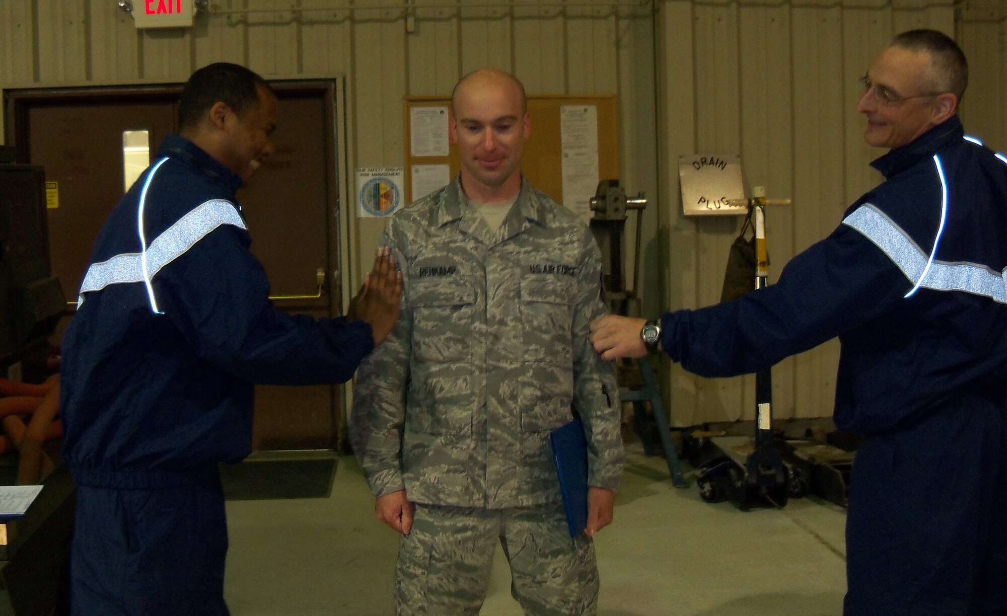 Staff Sgt. Karl Rehkamp (center), crew chief assistant, receives his technical sergeant stripes from Senior Master Sgt. Matt Turcotte and Tech. Sgt. Thomas Wihwaht during a recent drill weekend. (USAF photo courtesy of 916 MXS)