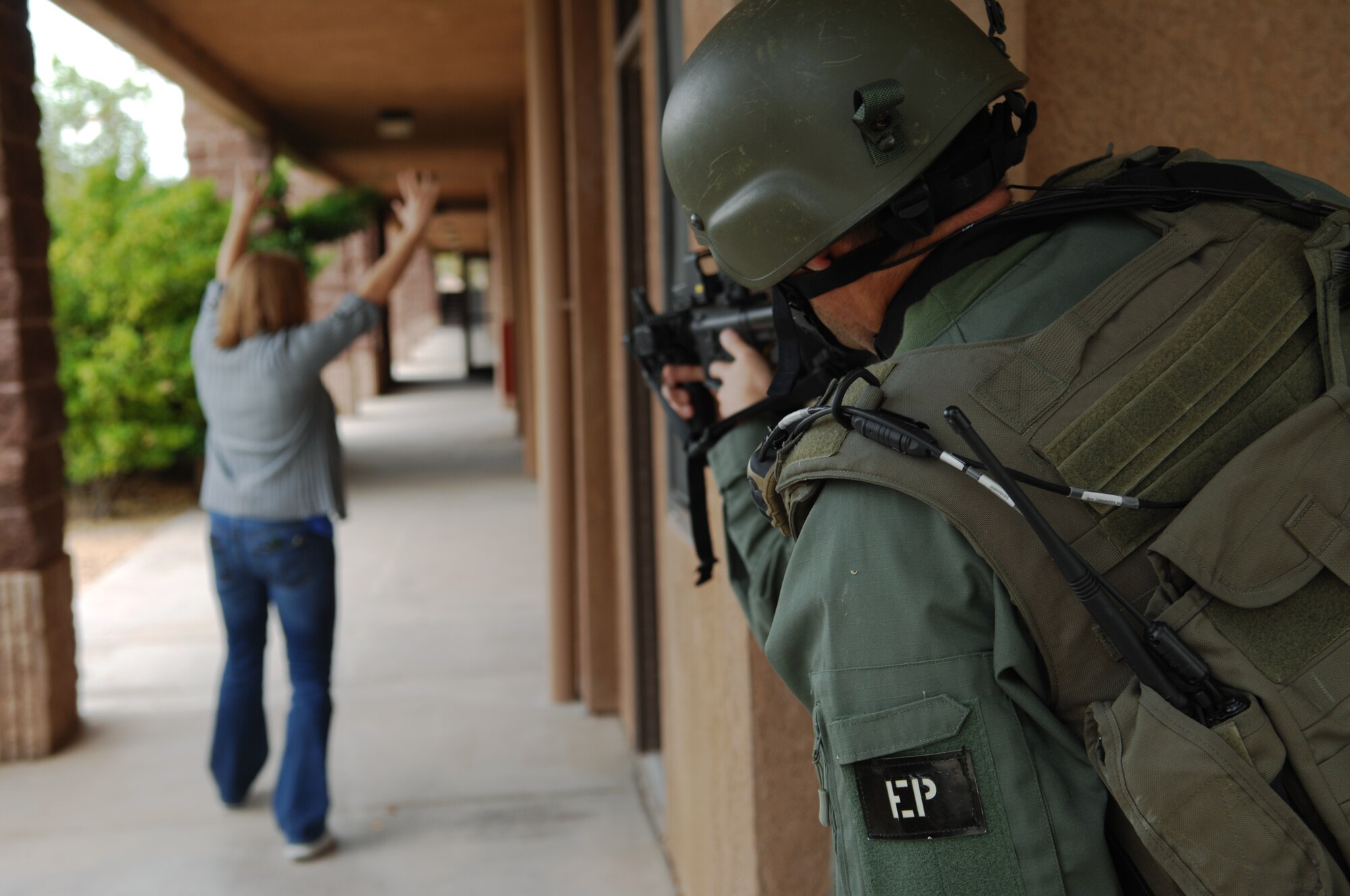 HOLLOMAN AIR FORCE BASE, N.M. -- Members of the El Paso Federal Bureau of Investigation give verbal commands to the wife of the alleged perpetrator during a hostage exercise April 28, 2010, at the base dormitories. The exercise involved 49th SFS Quick Reaction Force members, 49th SFS hostage negotiators; FBI hostage negotiators and FBI Special Weapons and Tactics teams from El Paso, Texas; Las Cruces and Albuquerque, N.M. Within the past year, Holloman security forces and the FBI have begun exercising joint Crisis Negotiation Team training.  This was the first exercise of its kind at Holloman involving both Crisis Negotiation and the SWAT teams. Future exercises are planned and will be larger in scope. (U.S. Air Force photo by Airman 1st Class Joshua Turner / Released)     