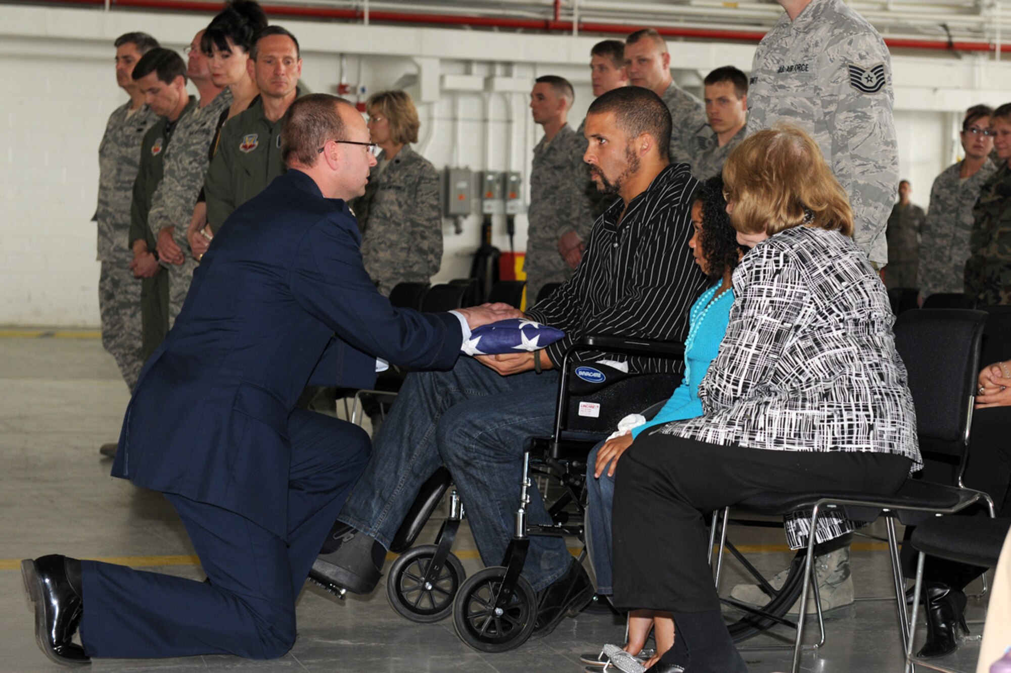 US Air Force Lt. Col. Michael F. Adamitis presents a flag to US Air Force Staff Sgt. Preston J. Cox for the loss of his fiancee, US Air Force Staff Sgt. Linda Monelavongsy, at a memorial service at Hancock Field in Syracuse, NY on 2 May 2010. The service was to celebrate the life of US Air Force Staff Sgt. Linda Monelavongsy who passed away in a motorcycle accident on 21 April 2010. (US Air Force photo by Staff Sgt. James Faso/Released)