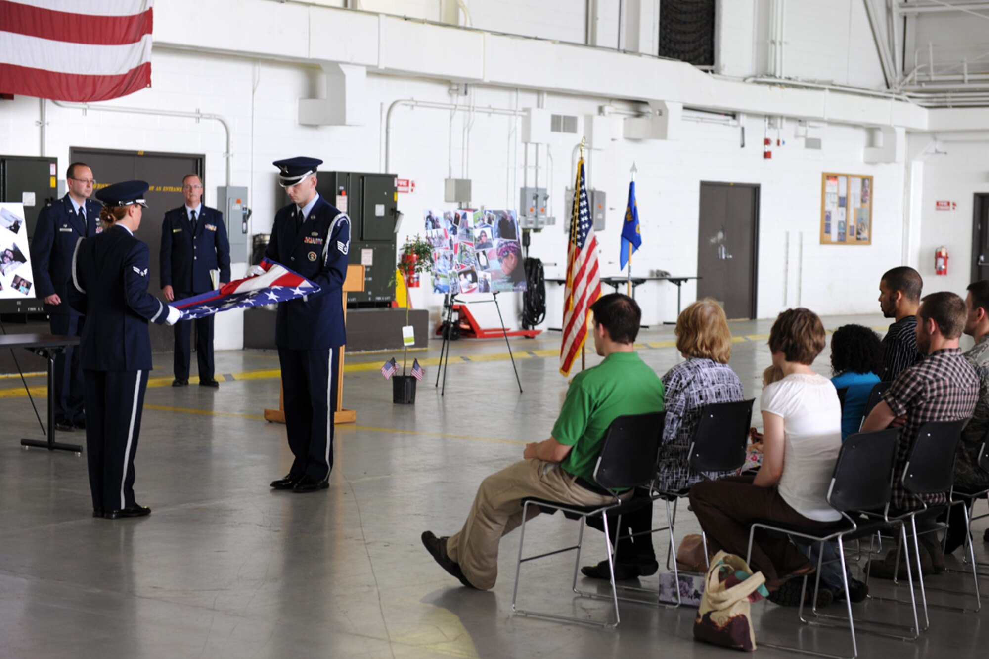 Members of the 174th Fighter Wing Honor Guard fold a flag at a memorial service at Hancock Field in Syracuse, NY on 2 May 2010. The service was to celebrate the life of US Air Force Staff Sgt. Linda Monelavongsy who passed away in a motorcycle accident on 21 April 2010. (US Air Force photo by Staff Sgt. James Faso/Released)