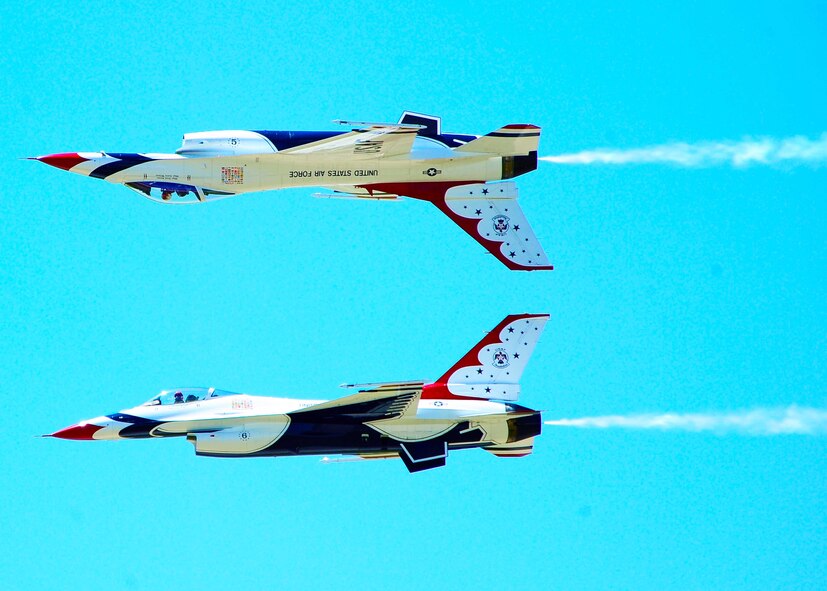DYESS AIR FORCE BASE, Texas-- The United States Air Force Thunderbirds lead solo, Major Rick Goodman, and Opposing Solo, Captain Aaron Jelinek, perform the Calypso Pass  for more than 30,000 spectators during the Dyess Big Country air fest, May 1. The Big Country air fest is held every other year on Dyess Air Force Base and features various aircraft performances as well as static displays. The air fest is held to bring the Abilene and Dyess communities together to demonstrate the capabilities of the Air Force. (U.S. Air Force photo/ Senior Airman Stephen Reyes)