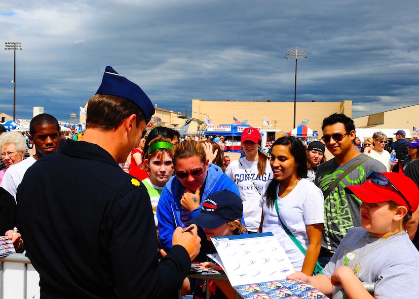 DYESS AIR FORCE BASE, Texas-- United States Air Force thunderbird pilot signs autographs for the public during the Dyess Big Country air fest here, May 1. The Big Country air fest is held every other year on Dyess Air Force Base and features various aircraft performances as well as static displays. The air fest is held to bring the Abilene and Dyess communities together to demonstrate the capabilities of the Air Force. (U.S. Air Force Photo/ Senior Airman Stephen Reyes)