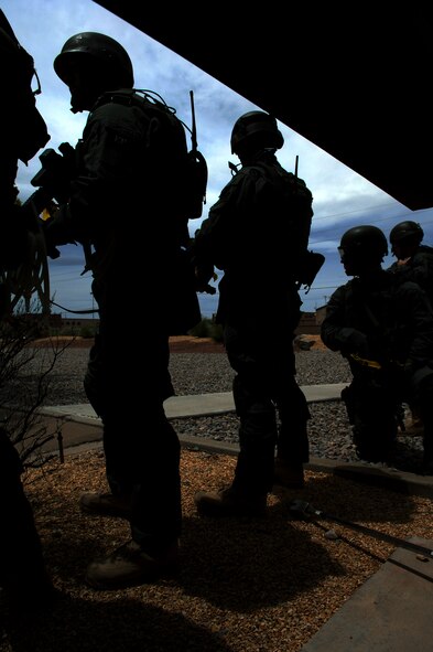 HOLLOMAN AIR FORCE BASE, N.M. -- Members of the El Paso Federal Bureau of Investigation stand guard during a hostage exercise April 28, 2010, at the base dormitories. The exercise involved 49th SFS Quick Reaction Force members, 49th SFS hostage negotiators; FBI hostage negotiators and FBI Special Weapons and Tactics teams from El Paso, Texas; Las Cruces and Albuquerque, N.M. Within the past year, Holloman security forces and the FBI have begun exercising joint Crisis Negotiation Team training.  This was the first exercise of its kind at Holloman involving both Crisis Negotiation and the SWAT teams. Future exercises are planned and will be larger in scope. (U.S. Air Force photo by Airman 1st Class Joshua Turner / Released)     