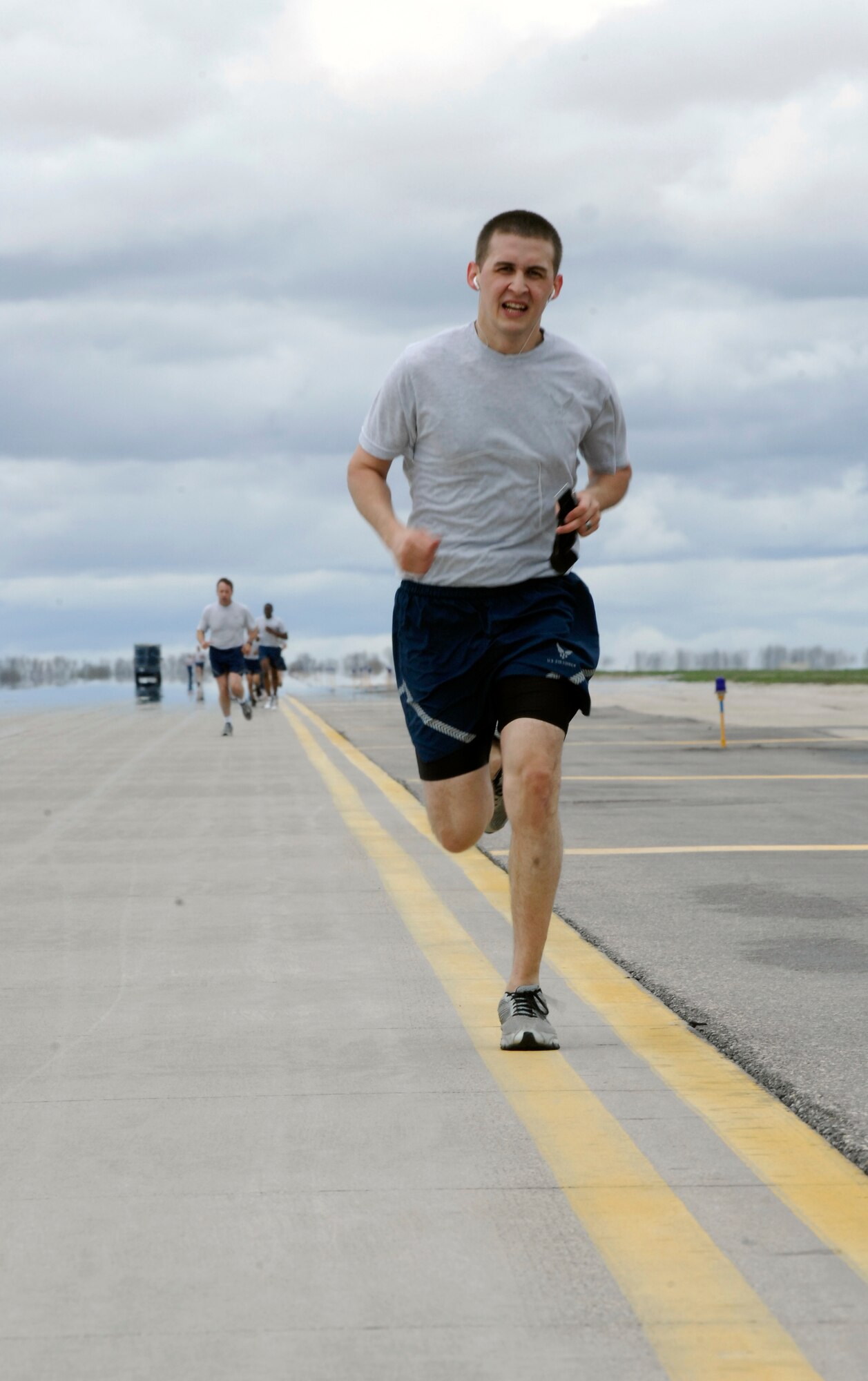 MINOT AIR FORCE BASE, N.D. – Airman 1st Class Adrian Perez, 5th Communications Squadron accountant, sprints to the finish line of the 1.5-mile Taxiway Delta Flightline Fitness Run here April 30. The flightline run is an annual event held to promote physical fitness, team building and enjoyment of the nice weather. (U.S. Air Force photo by Senior Airman Jesse Lopez)