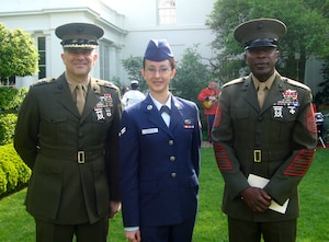 WASHINGTON, D.C. -- Airman 1st Class Ma Antonette Cabantog, 633d Force Support Squadron food services jouneyman, stands beside U.S. Marine Corps Maj. Gen. George J. Allen (left) and Sgt. Maj. of the Marine Corps Carlton Kent at the White House during the Oath of Allegiance ceremony April 23. Cabantog and 23 other servicemembers took the Oath of Allegiance, becoming American citizens. (Courtesy photo)