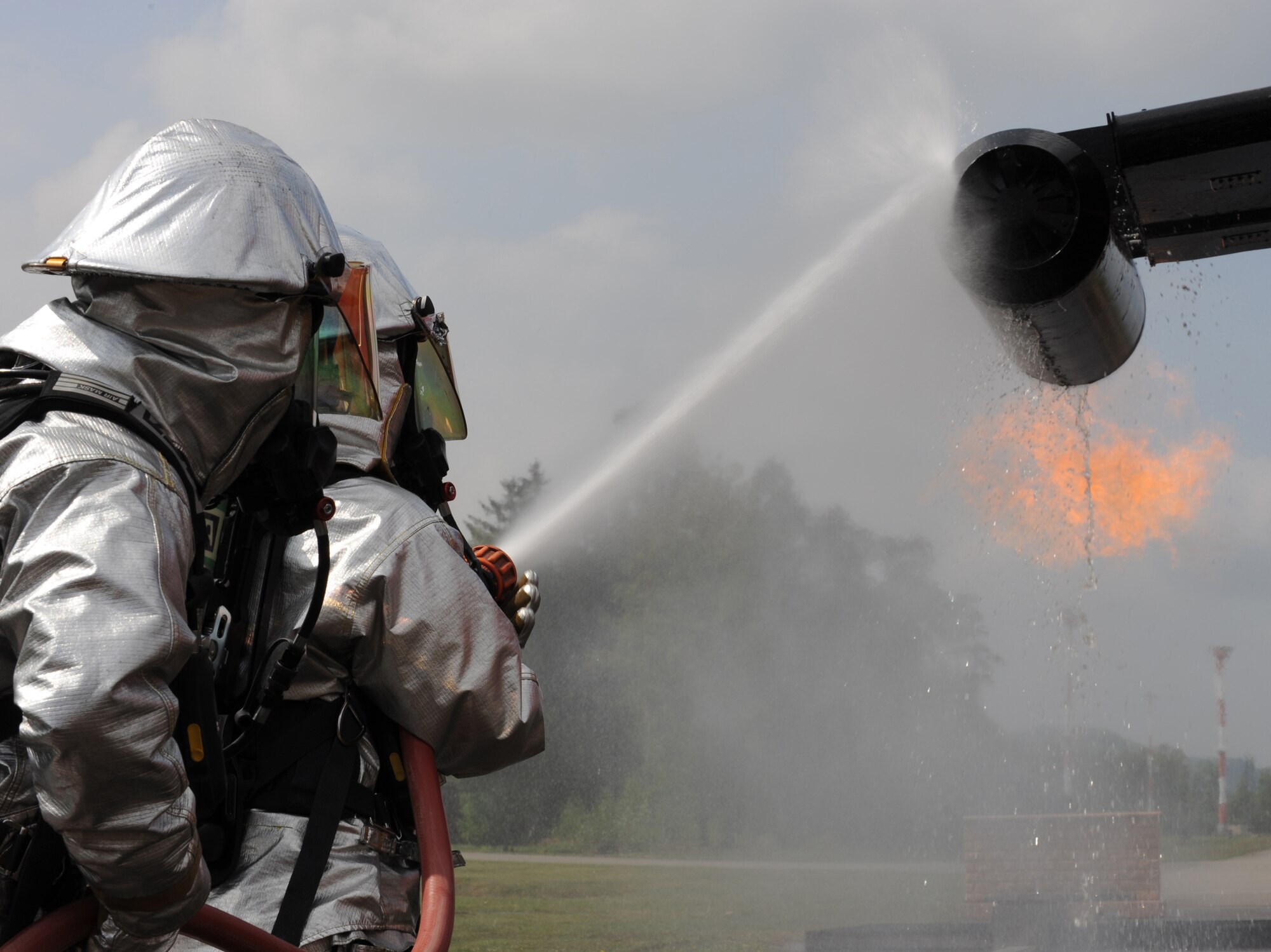 Firefighters from the 52nd Civil Engineer Squadron from Spangdahlem Air Base are evaluated during a training exercise, Ramstein Air Base, Germany, May 4, 2010. Firefighters train on several different types of aircraft fire scenarios to become more proficient in containing and putting out aircraft fires. (U.S. Air Force Photos by Airman 1st Class Caleb Pierce)