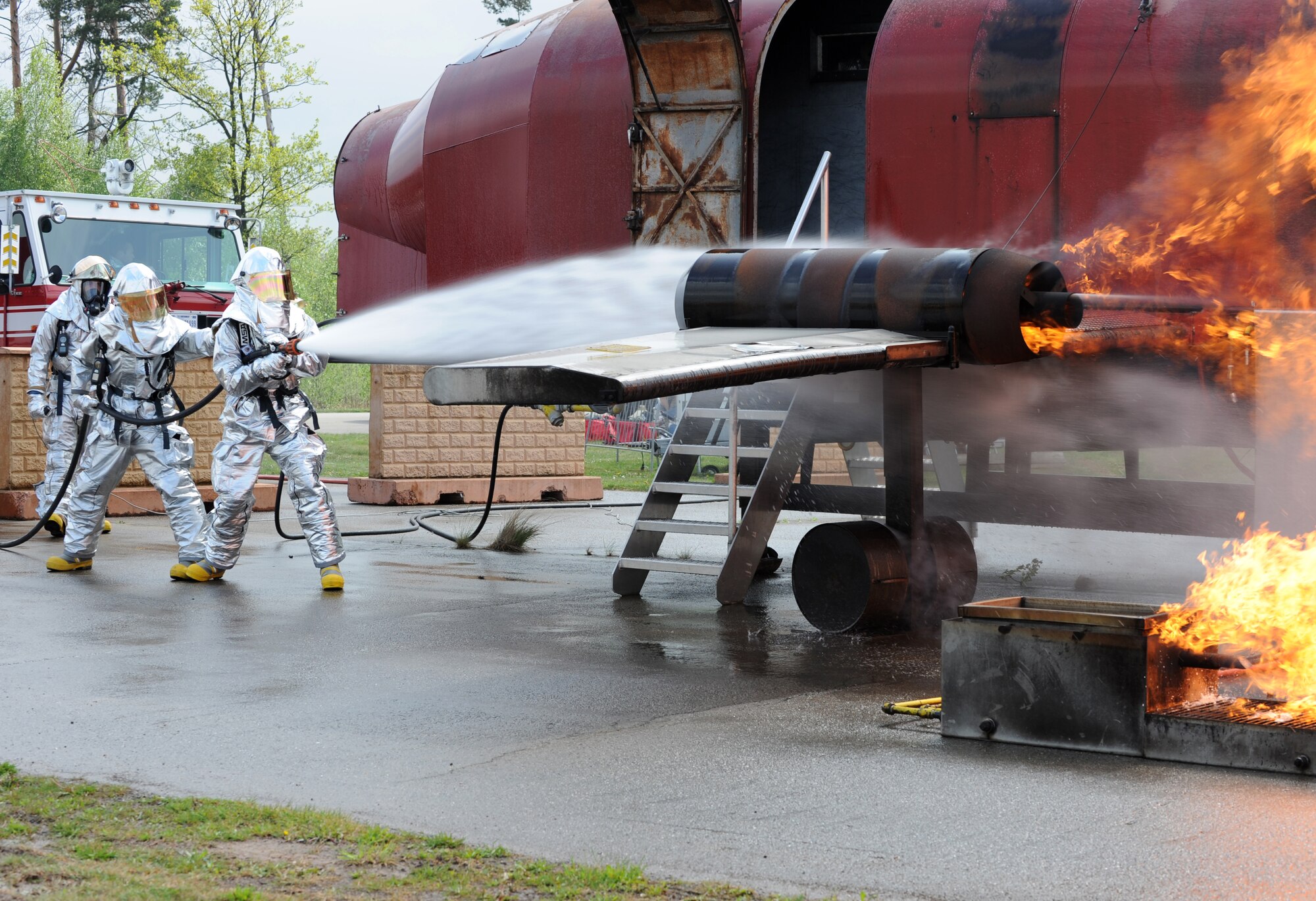 Firefighters from the 52nd Civil Engineer Squadron from Spangdahlem Air Base are evaluated during a training exercise, Ramstein Air Base, Germany, May 4, 2010. Firefighters train on several different types of aircraft fire scenarios to become more proficient in containing and putting out aircraft fires. (U.S. Air Force Photos by Airman 1st Class Caleb Pierce)