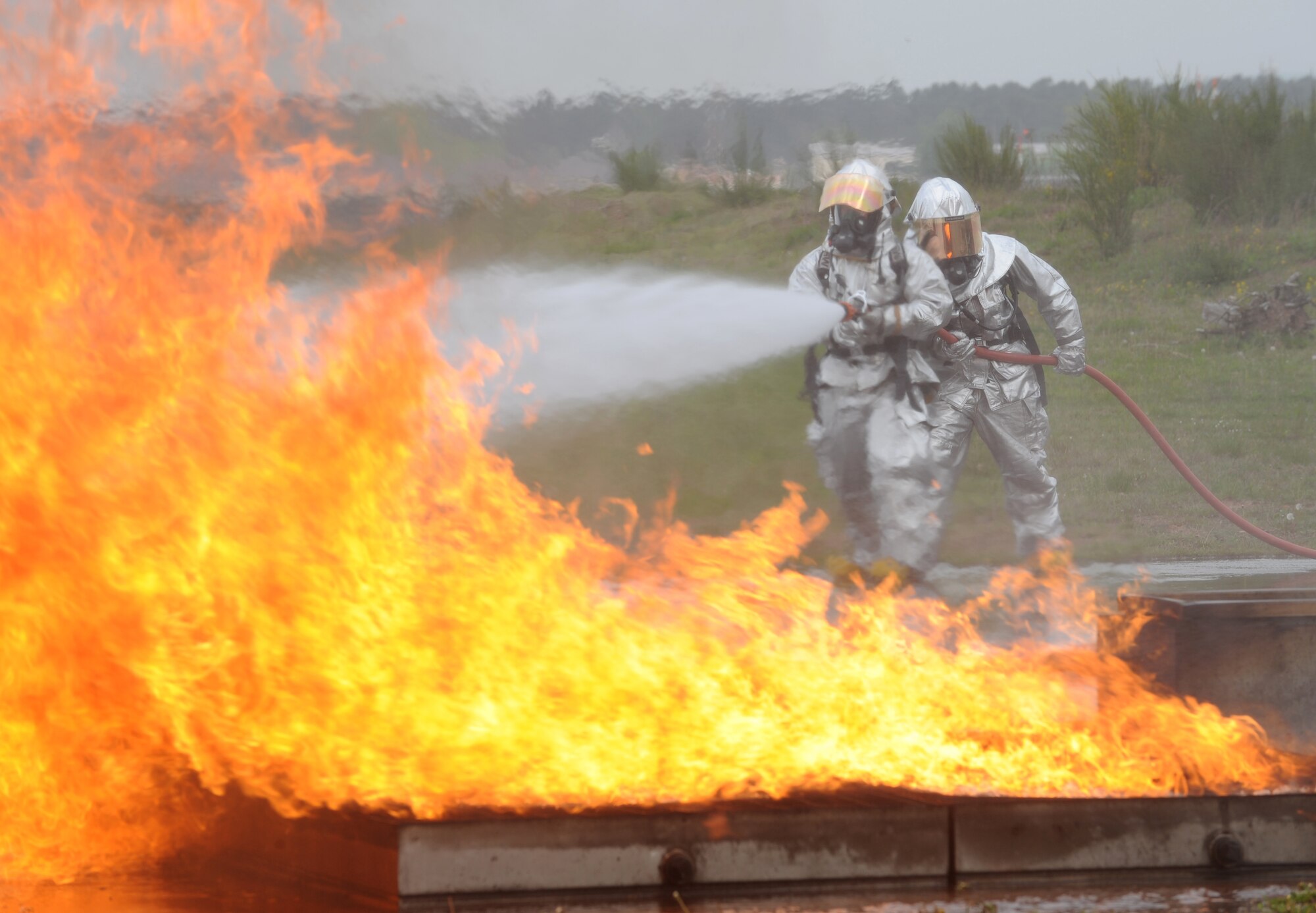Firefighters from the 52nd Civil Engineer Squadron from Spangdahlem Air Base are evaluated during a training exercise, Ramstein Air Base, Germany, May 4, 2010. Firefighters train on several different types of aircraft fire scenarios to become more proficient in containing and putting out aircraft fires. (U.S. Air Force Photos by Airman 1st Class Caleb Pierce)