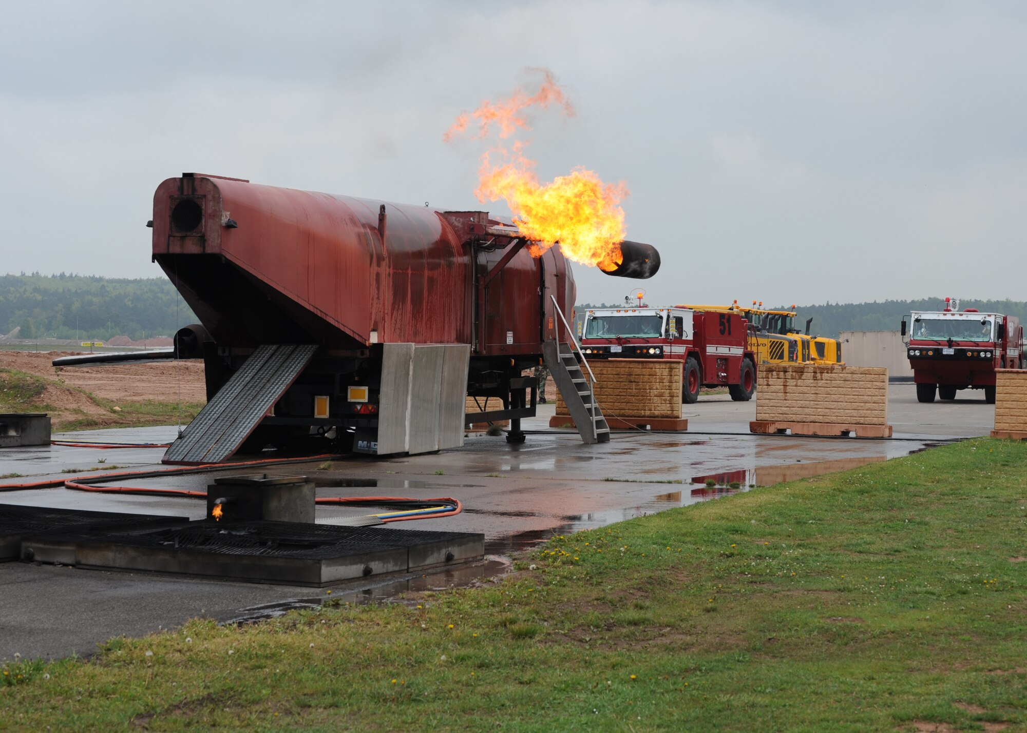 An aircraft fire training site is ignited in preparation of an evaluation, Ramstein Air Base, Germany, May 4, 2010. Firefighters train on several different types of aircraft fire scenarios to become more proficient in containing and putting out aircraft fires. (U.S. Air Force Photos by Airman 1st Class Caleb Pierce)