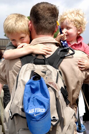Capt. Mark Hannon scoops up his two sons for the first time in months following his return from a four-month deployment to the Middle East. His sons, Austin and Logan were overcome with excitement and immediately jumped into his arms as he approached the waiting crowd of anxious families. Captain Hannon is a C-17 pilot with the 14th Airlift Squadron. (U.S. Air Force Photo/Airman 1st Class Lauren Main)