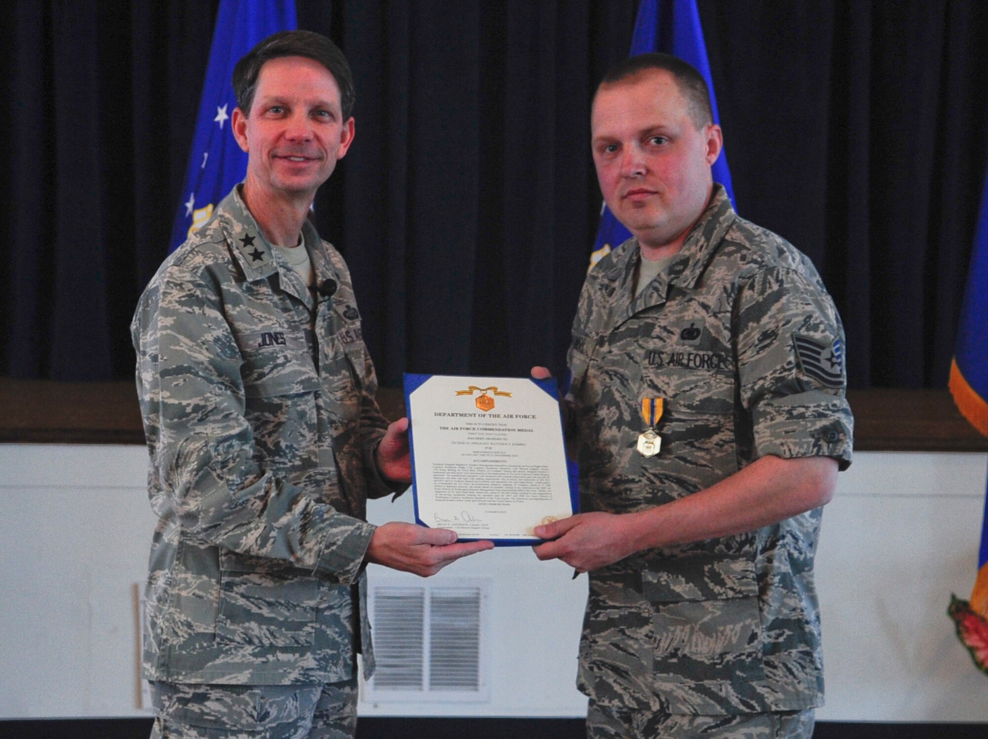 Air Force District of Washington Commander Maj. Gen. Darrell D. Jones, left, presented the Air Force Commendation Medal to Tech. Sgt. Matthew F. Kimbro, AFDW Material Management during the AFDW commander’s call April 29, 2010 at the Community Center, Andrews AFB, Md. (U.S. Air Force photo by Staff Sgt. Corenthia K. Fennell) 