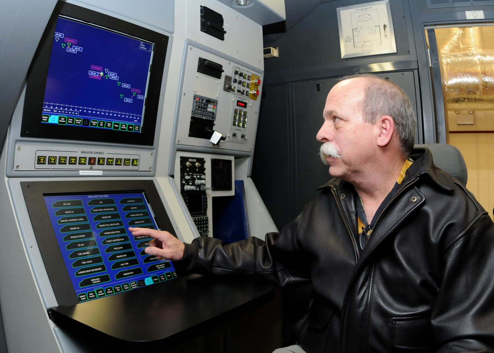 Bruce Golson, RAF Mildenhall's simulator site manager, works the simulator instructor operating station. This involves inputting different scenarios, such as a variety of weather conditions or emergency situations, which allow pilots to receive training without having to fly the actual jet. (U.S. Air Force photo/Staff Sgt. Jerry Fleshman)