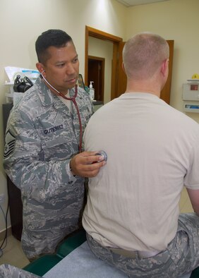 SOUTHWEST ASIA - U.S. Air Force Master Sgt. Roberto Gutierrez, an independent duty medical technician from the 386th Expeditionary Operations Support Squadron, listens to a patient's lungs May 1, 2010 at an air base here. There are fewer than 500 IDMTs in the Air Force and they are often assigned to flying units or organizations in isolated locations to tend to the units' medical needs. (U.S. Air Force photo by Capt. Joe Campbell/Released)