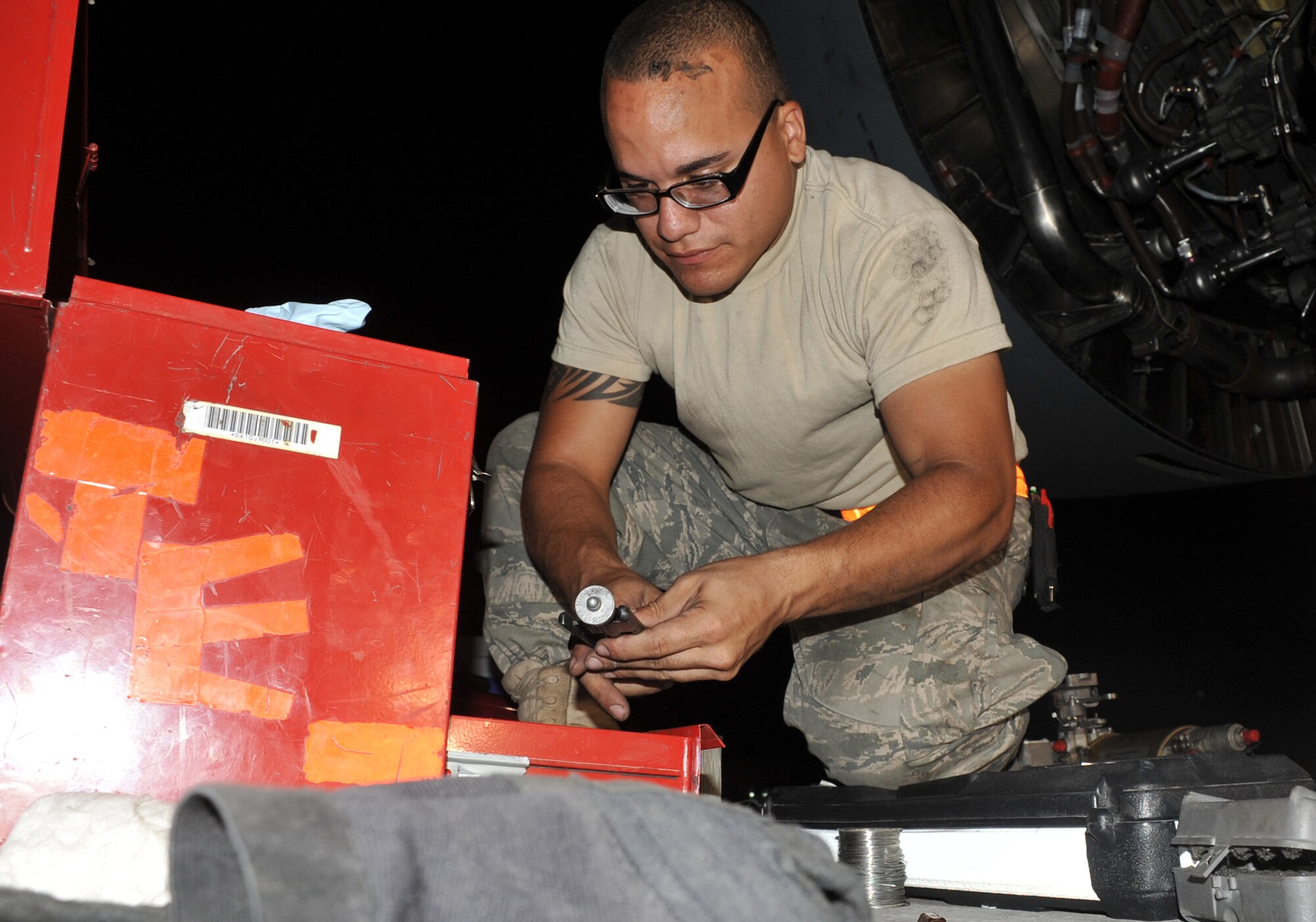 Senior Airman Alfonzo Pagan, an aerospace propulsion journeyman with the 380th Expeditionary Aircraft Maintenance Squadron Extender aircraft maintenance unit, works on a KC-10 during flightline operations at a non-disclosed base in Southwest Asia on May 1, 2010. He is deployed from the 605th Aircraft Maintenance Squadron, 305th Air Mobility Wing, Joint Base McGuire-Dix-Lakehurst, N.J. (U.S. Air Force Photo/Master Sgt. Scott T. Sturkol/Released)