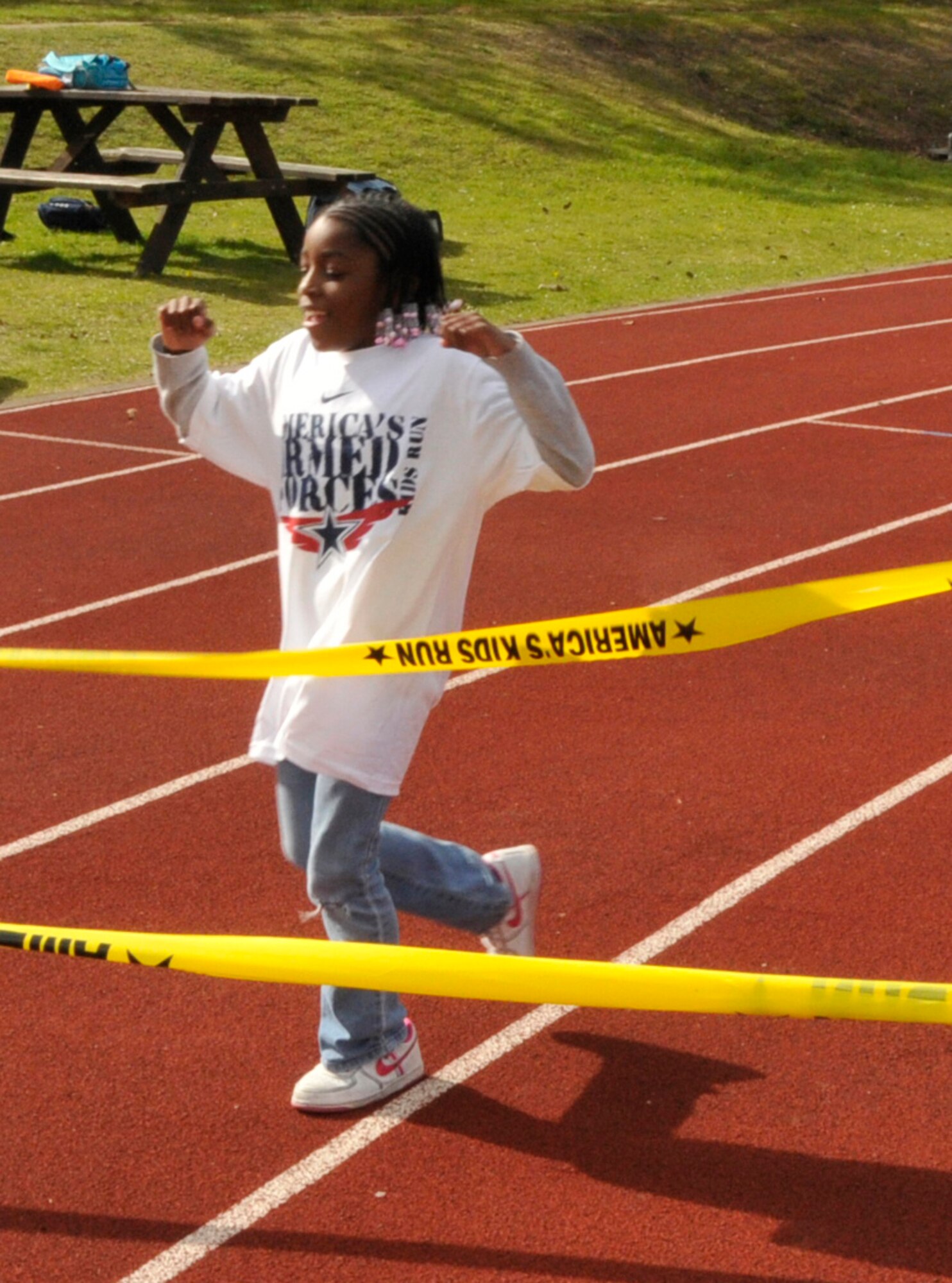 Adrianna Grant, 8, daughter of Tech. Sgt. Dawn Grant, 48th Mission Support Group NCO in charge of knowledge operations management, finishes the mile race for the 8-9 age group in fourth place during the 25th Annual Armed Forces Kids' Run May 3. The Armed Forces Kids' Run and Family Olympics are used to get families active together while having fun. (U.S. Air Force photo/Airman 1st Class Eboni Knox)