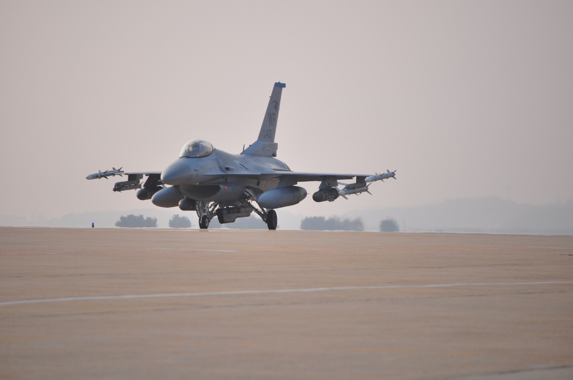 An F-16 Fighting Falcon taxis down the runway with live ordnance during a no notice exercise here April 23.
The Wolf Pack generated both F-16 Fighting Falcons and visiting F-15E Strike Eagles with live ordnance. During the day-long exercise base units were tested on their ability to successfully conduct the mission at a moment's notice; and unlike most exercises, this was completed with absolutely no warning. The exercise culminated with all aircraft taxiing to the end of the runway and then returning to their shelters. (Courtesy photo)