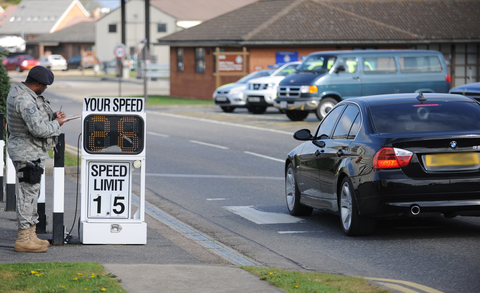 RAF MILDENHALL, England – Staff Sgt. Elvencie Prior, 100th Security Forces Squadron, annotates license plate numbers as vehicles pass a speed camera on RAF Mildenhall April 28. As the weather warms up, and more pedestrians begin to walk, security forces increases its number of speed check points at random times and places on base. (U.S. Air Force photo/ Staff Sgt. Jerry Fleshman)
