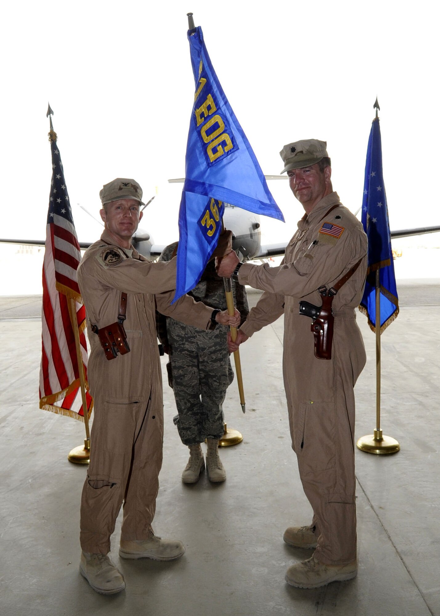 Col. John Cherrey, 451st Expeditionary Operations Group commander, activates the 361st Expeditionary Reconaissance Squadron May 1 while passing the guideon to Lt. Col. Darren Halford as the first commander of the new unit. (U.S. Air Force photo by Senior Airman Nancy Hooks/Released)