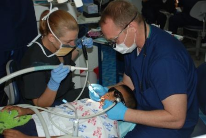 Staff Sgt. Angell Mann, Joint Task Force-Bravo dental assistant, and Capt. Nathaniel Caldon, JTF-Bravo dentist, provide dental care to a Honduran boy during a Dental Readiness Training Exercise in Tegucigalpa, Honduras, April 28. Members of JTF-Bravo and U.S. Dental Command conducted the DENTRETE April 19-29, treating 171 patients and performing 1,983 total procedures. (U.S. Air Force photo by 1st Lt. Jen Richard)