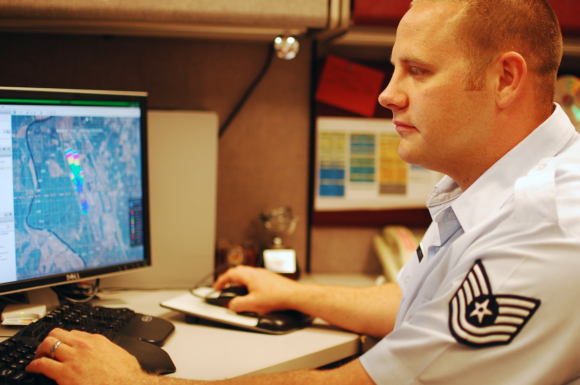 ASHEVILLE, N.C. -- Tech. Sgt. Adam Smith, an applications programmer with the 14th Weather Squadron here, works at his computer on May 3. Sergeant Smith recently earned the Outstanding Communications-Computer Systems NCO of the year award. He will accept the award in a formal ceremony in Washington D.C., next month. (Courtesy photo)
