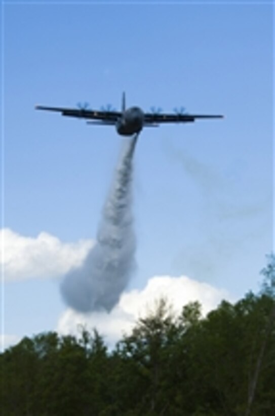 A U.S. Air Force C-130 Hercules aircraft from the 146th Airlift Wing in Port Hueneme, Calif., drops water over treetops in South Carolina as part of a Modular Airborne Firefighting System (MAFFS) training exercise on April 28, 2010.  The annual MAFFS training and certification is taking place in Greenville on April 26-30.  