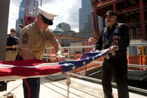 Marine Master Sgt. William Gibson, Jr, helps fold an American Flag, after it flew over the World Trade Center construction site, with a member of the Rolling Thunder, a veteran service member motorcycle organization, May 4, 2010. Rolling Thunder riders will bring the flag to the 2010 Warrior Games, Colorado Springs, Co. The competition for wounded service members will take place May 10-14 at the US Olympic Training Center. Gibson lost his leg during a 2006 Iraq firefight and will compete in the Warrior Games.