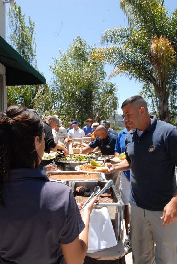 Golfers lined up to grab some chow before the awards and prizes were announced at the golf tournament.