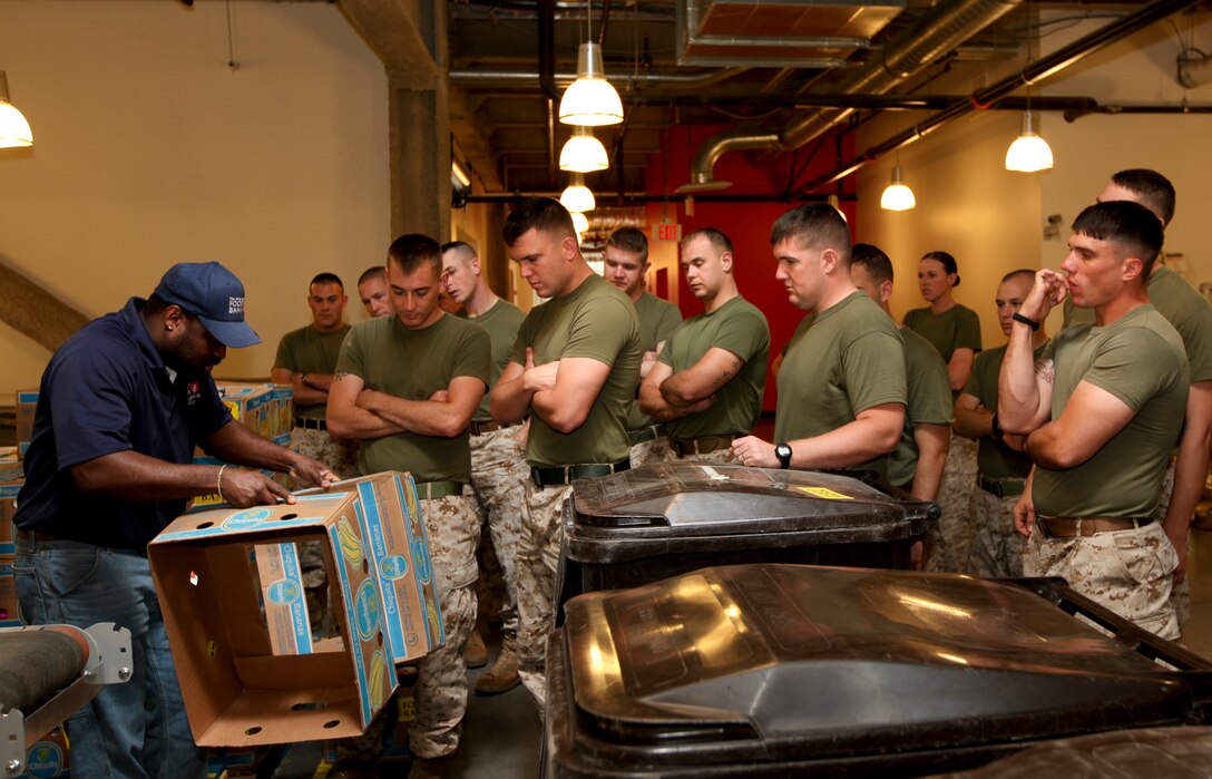Marines with Company L, 3rd Battalion, 24th Marine Regiment, are instructed by an employee of the Great Boston Food Bank on how they will be processing and packaging food while lending a hand to the facility May 4, 2010. The Marines are volunteering in support of Marine Week Boston, where they'll provide service to community groups, host physical fitness challenges and sports clinics in city parks and showcase state-of-the-art Marine vehicles, aircraft and equipment.