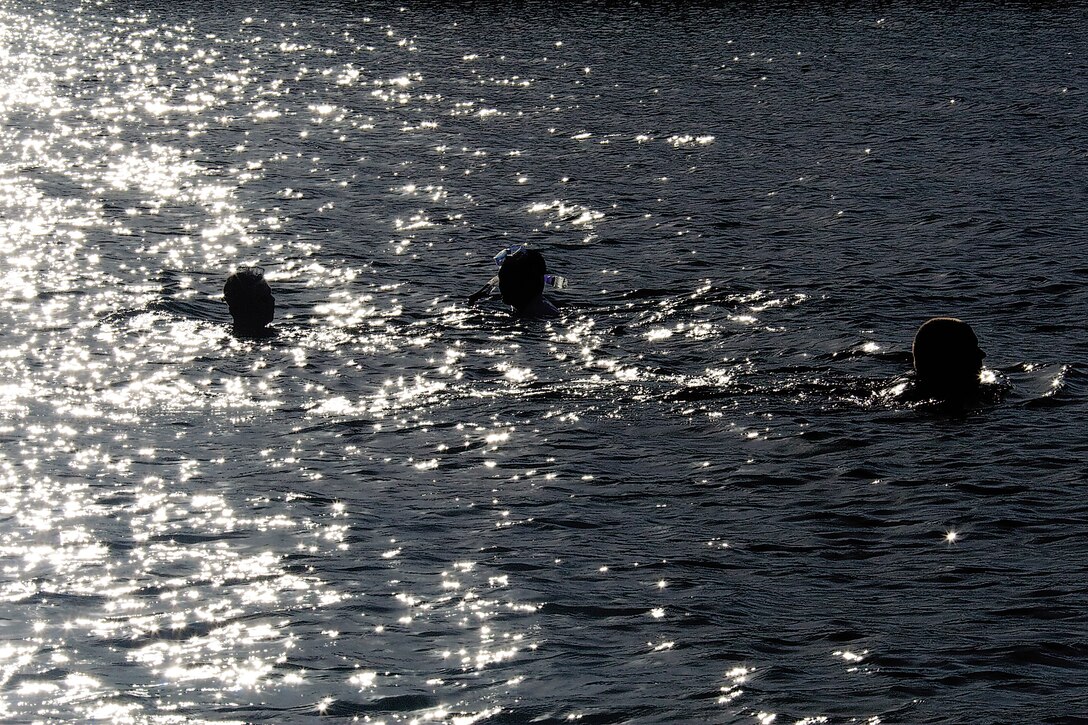 Members of Waterfront Operations swim back from a 500-yard marker during search and rescue training in Kaneohe Bay, May 4.