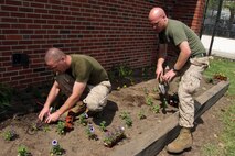 Sgt. Christopher Joyner and Lance Cpl. Phillip Koch, infantrymen with 3rd Battalion, 24th Marines, Lima Company from Johnson City, Tenn., dig and plant flowers during a combined effort with four volunteer organizations at Chestnut Hill Reservation in support of Marine Week Boston, May 3, 2010. Marines mingled with volunteers from the community to put forth a great effort to restore the park. The maintenance of the park is critical due to the recent status change of the reservoir because of the recent rupture of a water main in Boston. The Chestnut Hill Reservoir was an emergency backup source of water but now is supplying water to thousands of citizens in Boston; therefore the maintenance of the park is paramount.