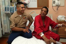 U. S. Marine Corps Reserve Staff Sgt. Gonzalo Cano, a Food Service Specialist with 3rd Battalion, 24th Marines out of St. Louis Mo., visits with retired Marine Gunnery Sgt. Wayne Crawford at the Veterans Affairs Boston Health Care System, West Roxbury Campus in support of Marine Week Boston on May 4, 2010. Crawford, a Boston native, served from 1976-1997 as a Water Purification Specialist.