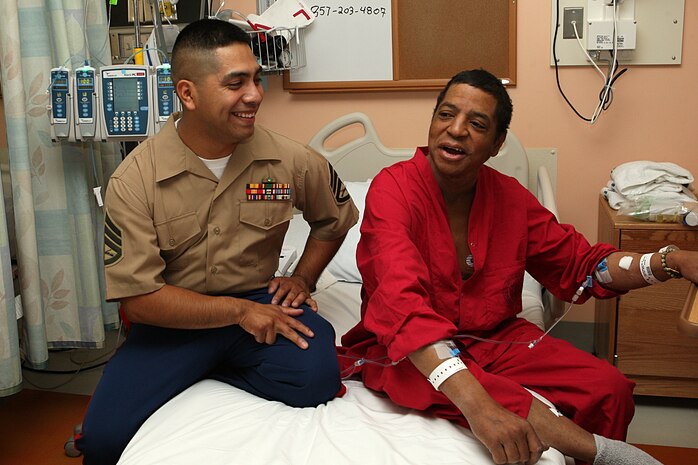 U. S. Marine Corps Reserve Staff Sgt. Gonzalo Cano, a Food Service Specialist with 3rd Battalion, 24th Marines out of St. Louis Mo., visits with retired Marine Gunnery Sgt. Wayne Crawford at the Veterans Affairs Boston Health Care System, West Roxbury Campus in support of Marine Week Boston on May 4, 2010. Crawford, a Boston native, served from 1976-1997 as a Water Purification Specialist.