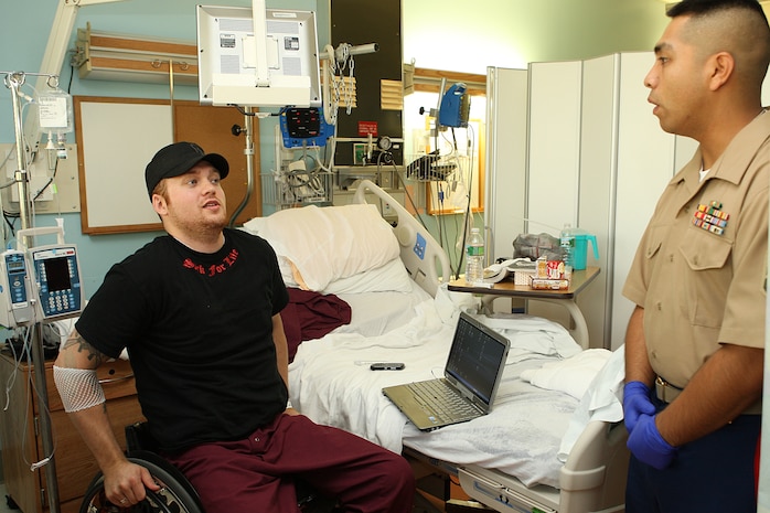 U. S. Marine Corps Reserve Staff Sgt. Gonzalo Cano, a Food Service Specialist with 3rd Battalion, 24th Marines out of St. Louis Mo., visits Lance Cpl. James Crosby at the Veterans Affairs Boston Health Care System, West Roxbury Campus in support of Marine Week Boston on May 4, 2010. Crosby, a Winthrop, Mass., native, suffered a spinal cord injury due to rocket fire in Al Asad, Iraq in support of Operation Iraqi Freedom, March 2004.