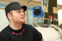U. S. Marine Corps Lance Cpl. James Crosby, a verteran of Operation Iraqi Freedom, talks with Marines visiting the Veterans Affairs Boston Health Care System, West Roxbury Campus in support of Marine Week Boston on May 4, 2010. Crosby, a Winthrop, Mass., native, suffered a spinal cord injury due to rocket fire in Al Asad, Iraq in support of Operation Iraqi Freedom, March 2004.