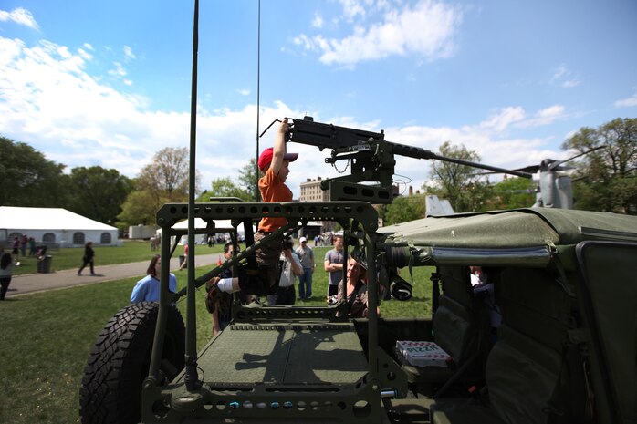 Jack Guy, a 2-year-old Boston native trades in his super soaker for a .50 caliber heavy machine gun at Boston Common May 4, 2010. Numerous vehicle and weapon displays were available for the Boston public as part of Marine Week May 3-9. The week's events are an opportunity to share the Corps' culture, history and tradition with Bostonians and for them to learn about the Corps' value to the nation.