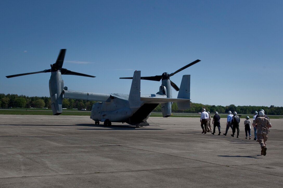 Members of the board of trustees for the USS Constitution museum file into the back of a MV-22 Osprey at Hanscom Air Force Base May 4, 2010. The Osprey is part of the aviation displays available during Marine Week May 3-9.