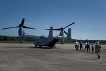 Members of the board of trustees for the USS Constitution museum file into the back of a MV-22 Osprey at Hanscom Air Force Base May 4, 2010. The Osprey is part of the aviation displays available during Marine Week May 3-9.