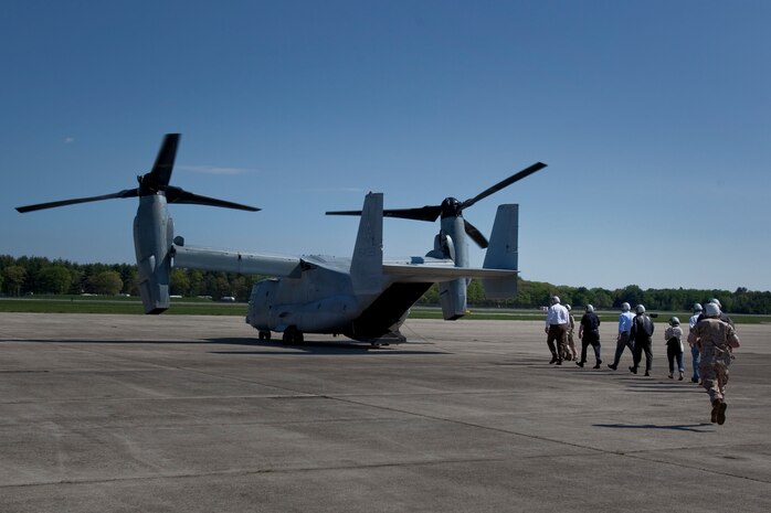 Members of the board of trustees for the USS Constitution museum file into the back of a MV-22 Osprey at Hanscom Air Force Base May 4, 2010. The Osprey is part of the aviation displays available during Marine Week May 3-9.