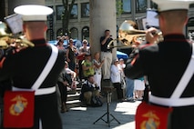 Local Boston residents watch Albany Marine Band performs, ''The Song of Marines,'' at Faneuil Hall Marketplace in Boston, Mass., May 4, 2010, for Marine Week Boston.  Albany Marine Band marched from Faneuil Hall Marketplace to Boston Common, playing several songs to include, ''Stars and Stripes, Marines' Hymn, What a Wonderful World and Semper Fi.''?The band's performance played a key role in Marine Week Boston to share the Corps' traditions, history and culture with Bostonians and help them learn about the Corps' value to the nation.