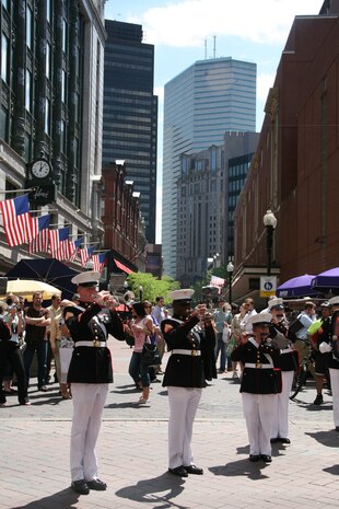 Albany Marine Band performs ''God Bless America,'' in downtown Boston, Mass., in a crowd of surrounding Bostonians, May 4, 2010, for Marine Week Boston.  Albany Marine Band performed several songs to include, ''Stars and Stripes, Marines' Hymn, What a Wonderful World and Semper Fi.'' The band's performance played a key role in Marine Week Boston to share the Corps' traditions, history and culture with Bostonians and help them learn about the Corps' value to the nation.