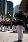 Staff Sgt. Ignatius J. Keogh, the enlisted conductor for Albany Marine Band and native of Rochester, N.Y., conducts band members as they play ''God Bless America,'' in downtown Boston, Mass., in a crowd of surrounding Bostonians, May 4, 2010, for Marine Week Boston. Albany Marine Band performed several songs to include, ''Stars and Stripes, Marines'?? Hymn, What a Wonderful World and Semper Fi.'' The band's performance played a key role in Marine Week Boston to share the Corps' traditions, history and culture with Bostonians and help them learn about the Corps' value to the nation.