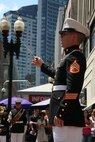 Staff Sgt. Ignatius J. Keogh, the enlisted conductor for Albany Marine Band and native of Rochester, N.Y., conducts band members as they play ''God Bless America,'' in downtown Boston, Mass., in a crowd of surrounding Bostonians, May 4, 2010. Albany Marine Band performed several songs to include, ''Stars and Stripes, Marines' Hymn, What a Wonderful World and Semper Fi.''?The band's performance played a key role in Marine Week Boston to share the Corps' traditions, history and culture with Bostonians and help them learn about the Corps' value to the nation.