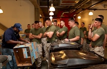 Marines with Company L, 3rd Battalion, 24th Marine Regiment, are instructed by an employee of the Great Boston Food Bank on how they will be processing and packaging food while lending a hand to the facility May 4, 2010. The Marines are volunteering in support of Marine Week Boston, where they'll provide service to community groups, host physical fitness challenges and sports clinics in city parks and showcase state-of-the-art Marine vehicles, aircraft and equipment.